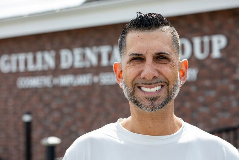 Gitlin dental group patient smiling outside